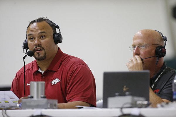 Geno Bell, left, works with Arkansas radio announcer Chuck Barrett during a practice Saturday, April 29, 2017, at Walker Pavilion in Fayetteville. Bell was a defensive lineman at Arkansas in the 1990s.