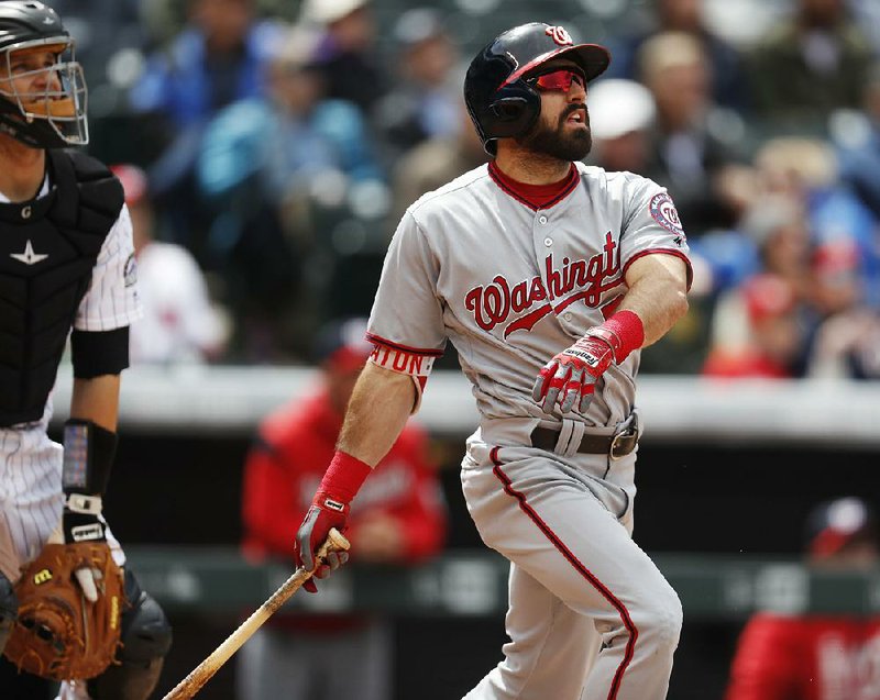 Washington Nationals' Adam Eaton watches his solo home run in front of Colorado Rockies catcher Dustin Garneau during the fifth inning of a baseball game Thursday, April 27, 2017, in Denver. 