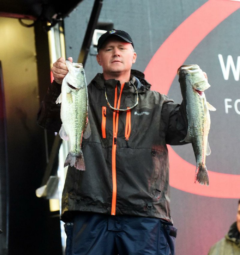 Johnny McCombs of Morris, Ala., caught five bass weighing 18 pounds, 15 ounces Saturday and jumped from 11th place to first in the FLW Tour event on Beaver Lake. 