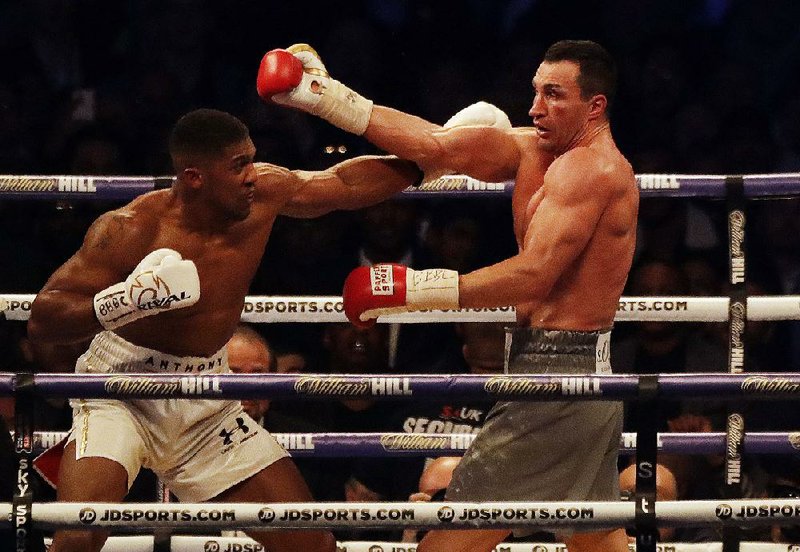 Anthony Joshua (left) knocked out Wladimir Klitschko with an uppercut in the 11th round Saturday in London. 