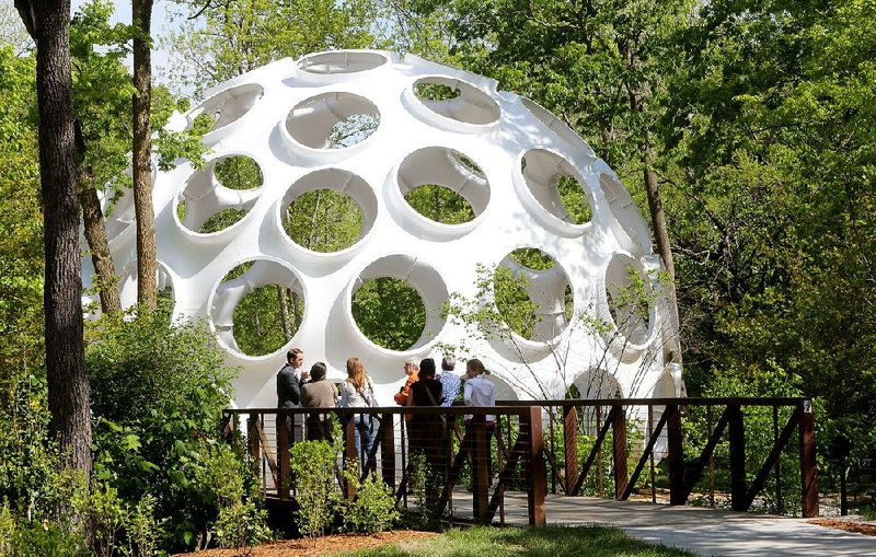 Fly’s Eye Dome, a fi berglass structure created by architect and engineer Buckminster Fuller, can be seen from inside the Crystal Bridges Museum of American Art in Bentonville. The dome will be open to the public in July.