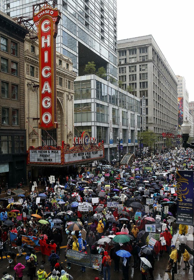 People march Saturday in Chicago near Trump Tower to protest President Donald Trump’s environmental policies. As Trump marked his 100th day in office, thousands of people across the U.S. took to the streets to demand action on climate change.