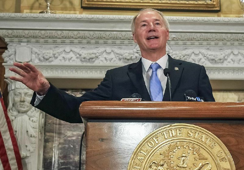 At a news conference Friday at the state Capitol, Gov. Asa Hutchinson explained why the state budget is being cut $70 million in this fiscal year, which ends June 30.