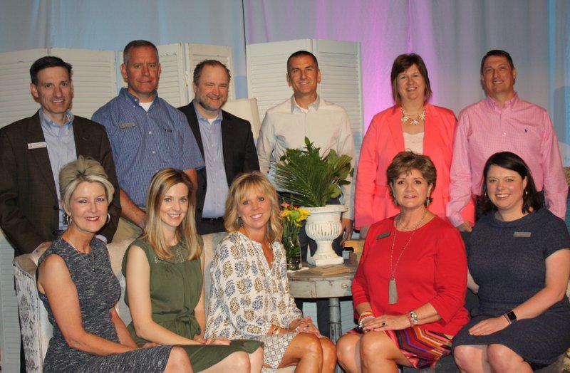 Susan Goss (seated, from left), Sarah Hickman Gilmer, Jan Shinall, Cookie Parker, Julie Gehrki, James Vawter (standing, from left) Mark Gerth, Bryan Looney, Adam Maass and Becky and Kent Shaffer, Saving Grace Board of Directors members, welcome guests to Butterflies and Blooms on April 20.