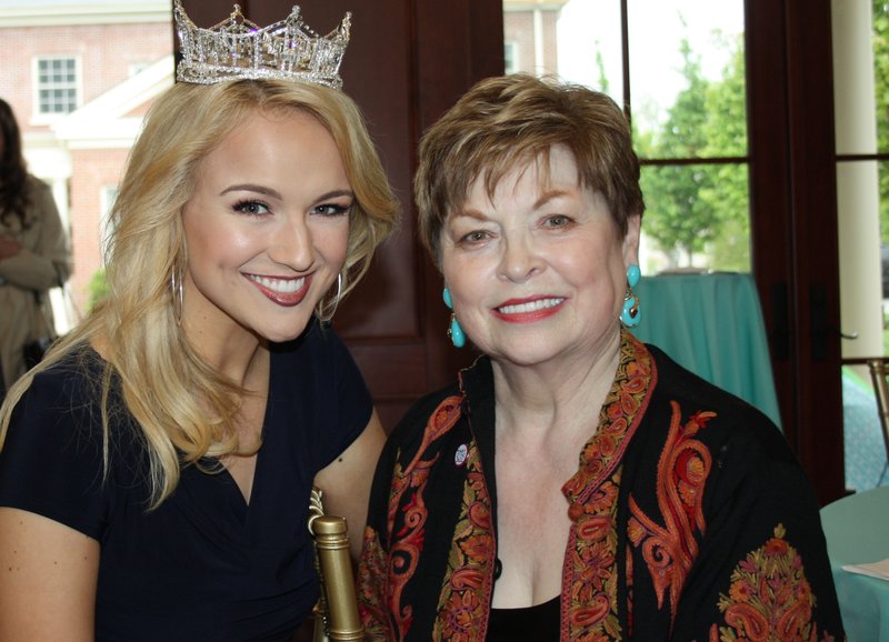 NWA Democrat-Gazette/CARIN SCHOPPMEYER Savvy Shields, Miss America (left), visits with Donna Axum Whitworth, Miss America 1964 and a founding member of the University Women&#8217;s Giving Circle, at a reception in Axum Whitworth&#8217;s honor April 20 at the Fowler House Conservatory on the UA campus in Fayetteville.