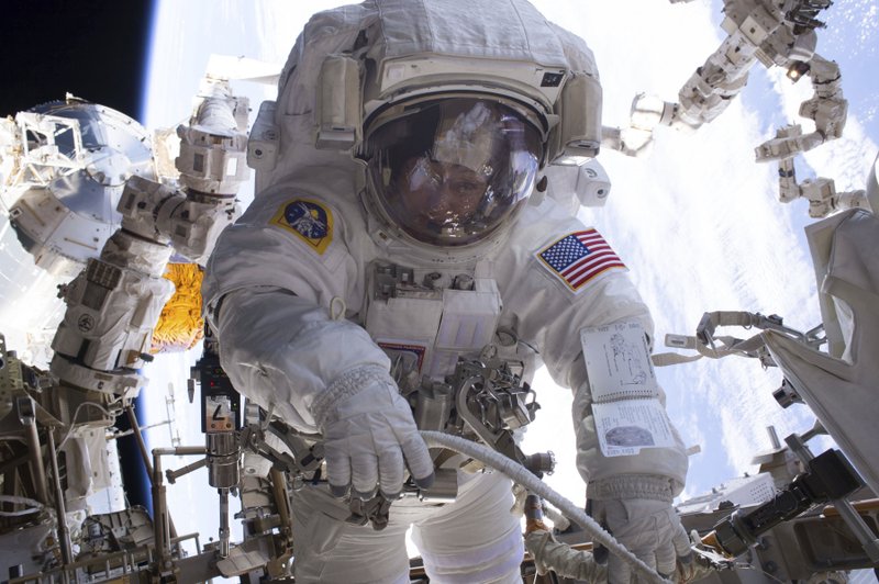 In this Jan. 6, 2017 photo made available by NASA, astronaut Peggy Whitson performs a spacewalk during Expedition 50 aboard the International Space Station. According to a report released Wednesday, April 26, 2017, NASA is managing a variety of design and health risks associated with the spacewalking suits used by astronauts aboard the International Space Station. The suits were developed more than 40 years ago and intended for only 15 years' use.