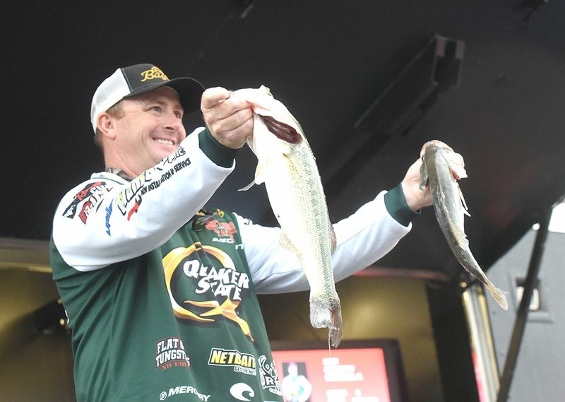 NWA Democrat-Gazette/FLIP PUTTHOFF Scott Canterbury of Springville, Ala., who won the 2016 FLW tournament at Beaver Lake, shows two bass Saturday from his five-fish limit that weighed 11 pounds, 10 ounces.