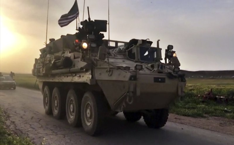 This Friday, April 28, 2017 still taken from video, shows U.S. forces patrolling on a rural road in the village of Darbasiyah, in northern Syria. U.S. armored vehicles are deploying in areas in northern Syria along the tense border with Turkey, a few days after a Turkish airstrike that killed 20 U.S.-backed Kurdish fighters, a Syrian war monitor and Kurdish activists said Friday. 