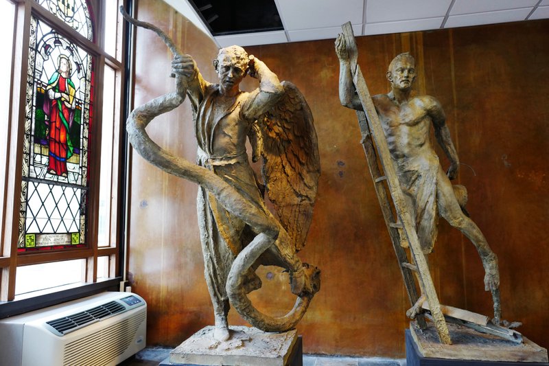 Sculptures of St. Michael the Archangel, center, the patron saint of police officers, and St. Florian, the patron saint of firefighters, are featured in St. Joseph's Chapel, Thursday, April 27, 2017, in New York. Parishioners are praying to save the chapel, which is living on archdiocese subsidies after the rent tripled to $264,000 a year. 