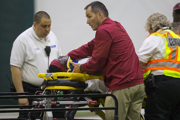 Running back Rawleigh Williams is placed on a cart after suffering an injury during Arkansas football practice on Saturday, April 29, 2017, inside Walker Pavilion in Fayetteville.