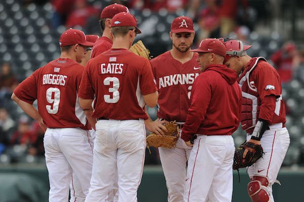 Pitching coach Wes Johnson and players huddle as Arkansas plays Ole Miss Friday, April 28, 2017 at Baum Stadium in Fayetteville.