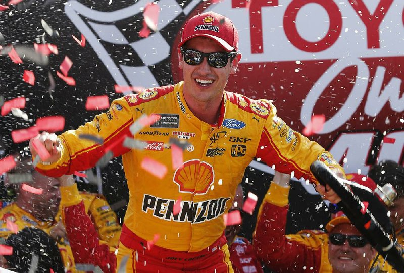 Joey Logano celebrates after winning the NASCAR Cup Series auto race in Victory Lane at Richmond International Raceway in Richmond, Va., Sunday, April 30, 2017. 