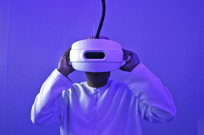 An Emirati man watches through a special viewfi nder at the Museum of the Future during the opening day of the World Government Summit in Dubai, United Arab Emirates, in February. As Dubai embraces technology, it also must keep its cyberdefenses up-to-date.