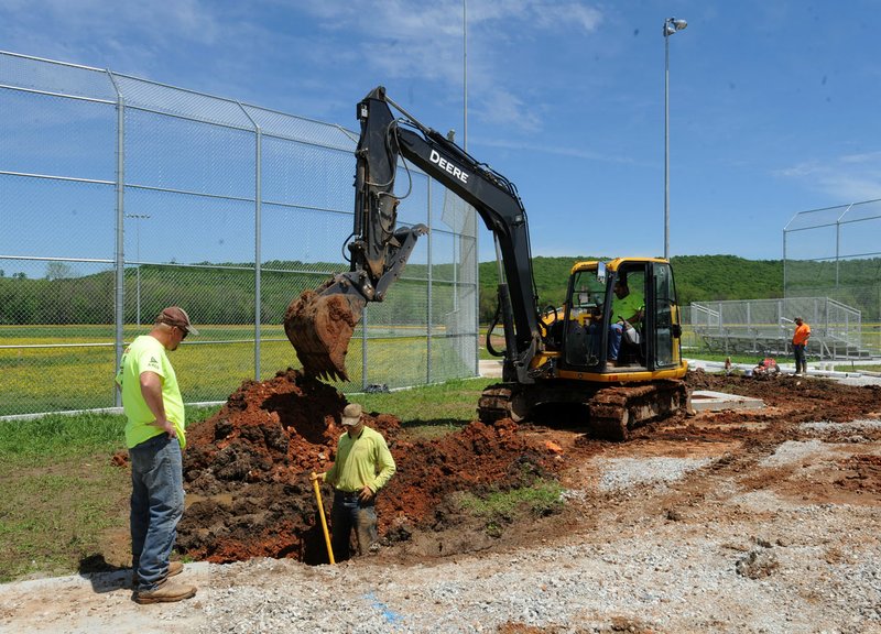 Workers with ARCO Excavation and Paving install and test utility lines Thursday at the new Elkins sports complex.