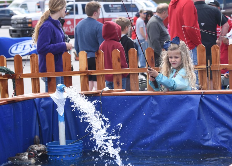 Harper Jones, 5, tries her luck fishing in the trout tank at the FLW expo on Sunday.