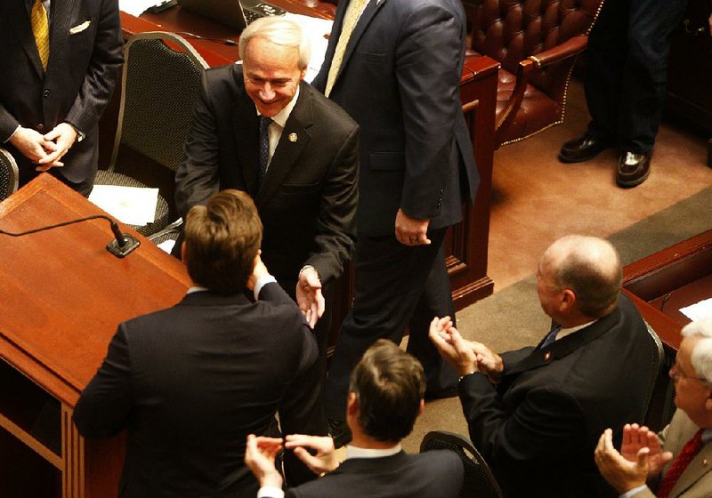 Gov. Asa Hutchinson on Monday greets lawmakers in the House chamber before his address to a joint session of the Legislature at the beginning of a special session he called to make changes to Arkansas Works.