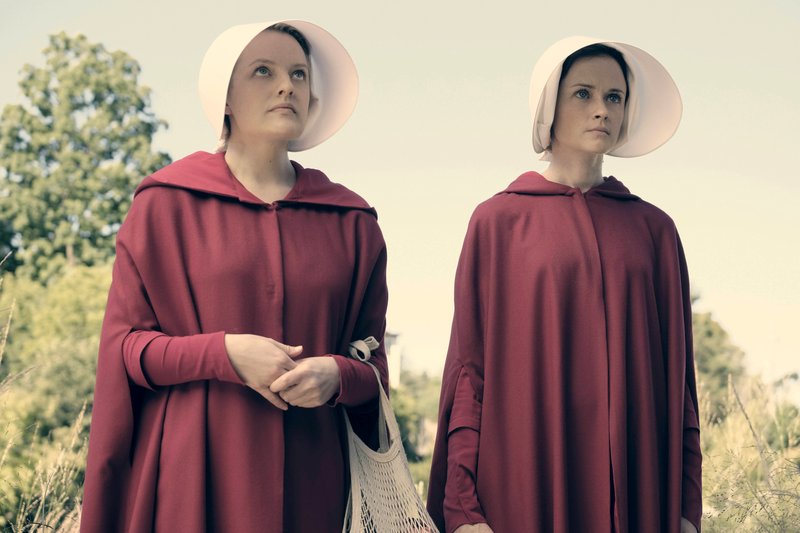 Elisabeth Moss stars as Offred (left) and Alexis Bledel is Ofglen in a remake of The Handmaid's Tale on Hulu.  