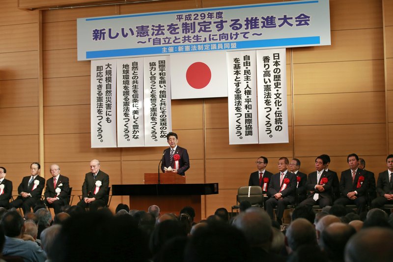 Japanese Prime Minister Shinzo Abe, center, makes a speech during the annual rally on revising Japan's constitution organized by ruling party lawmakers in Tokyo, Monday, May 1, 2017. Abe has pledged to initiate debate in parliament on revising the country's U.S.-drafted constitution. The democratic and pacifist charter took effect 70 years ago on May 3. 