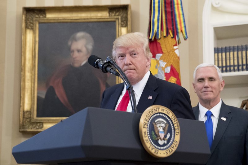 FILE - In this March 31, 2017 file photo, a portrait of former President Andrew Jackson hangs on the wall behind President Donald Trump, accompanied by Vice President Mike Pence, in the Oval Office at the White House in Washington. President Donald Trump made puzzling claims about Andrew Jackson and the Civil War in an interview, suggesting that he was uncertain about the origin of the conflict while claiming that Jackson was upset about the war that started more than a decade after his death. (AP Photo/Andrew Harnik, File)