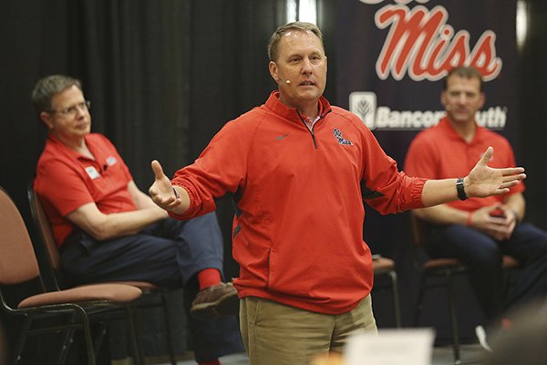 Mississippi football coach Hugh Freeze speaks to the alumni gathered during the Rebel Roadshow as Chancellor Jeff Vitter, left, and Athletic Director Ross Bjork, right, sit nearby, Wednesday evening, April 26, 2017, in Tupelo, Miss. (Lauren Wood/Northeast Mississippi Daily Journal via AP)

