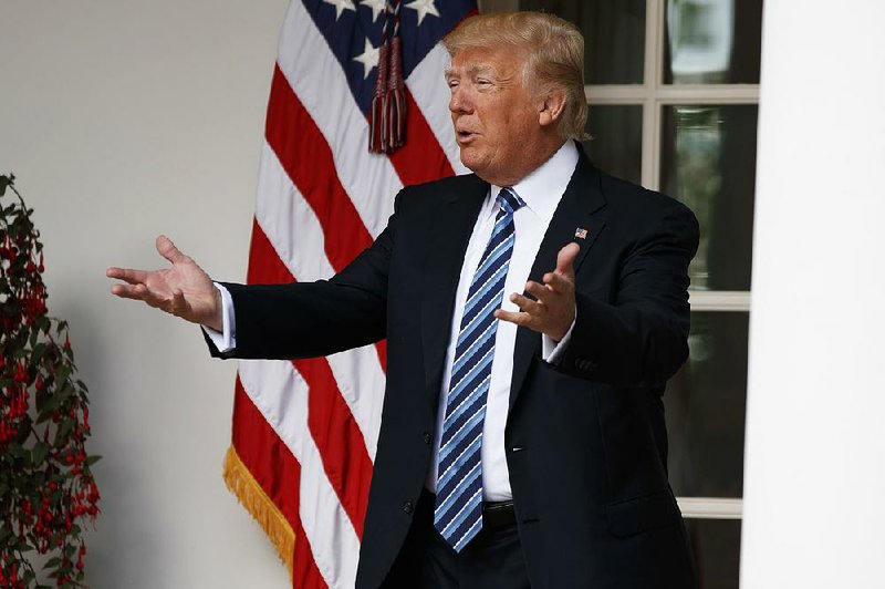 President Donald Trump talks to reporters Tuesday, a day when he expressed his displeasure over the stopgap spending agreement and then touted it as “a clear win for the American people.”