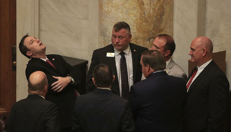 House Speaker Jeremy Gillam (left) joins fellow lawmakers Tuesday during a recess in House proceedings. 