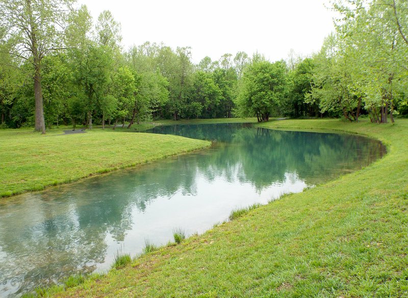 Photo by Randy Moll The spring-fed pond at the Flint Creek Nature Area was surrounded by inviting green trees on a rainy day in Gentry on Friday, April 28, 2017.