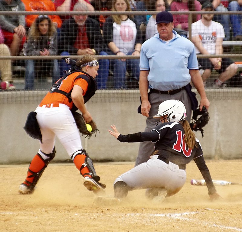 Photo by Randy Moll Halley Laster, Pea Ridge No. 10, slides safely across home plate for the game-winning run as Emily Ellis, Gravette&#8217;s catcher, receives the throw during Friday&#8217;s (April 28, 2017) district championship game at Gravette High School.