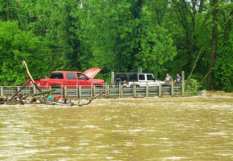 Photo by Randy Moll Several people were stranded on the bridge just north of the Ozark Adventist Academy in Gentry on Saturday afternoon. Two more cars were stalled in the flood waters to the north of the bridge, with water up over the hood on one vehicle.