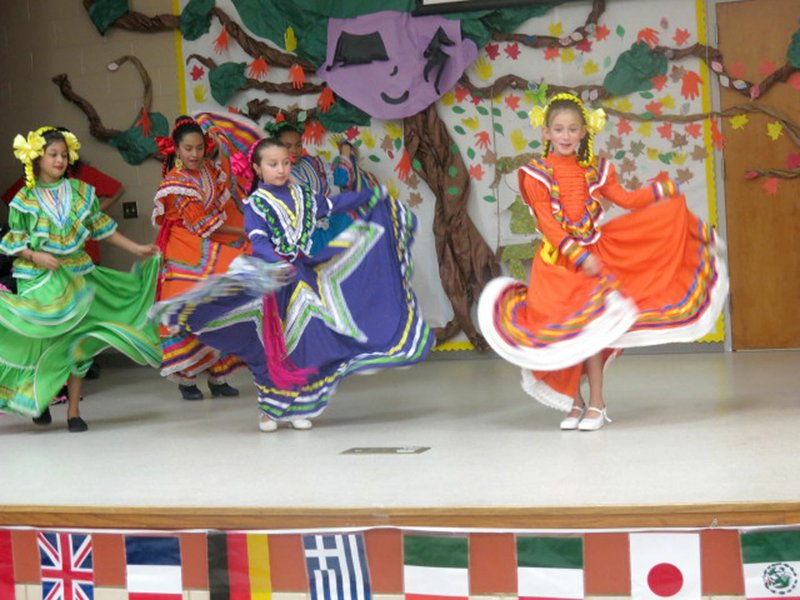 Photo by Susan Holland Some of the younger dancers from the Ballet Folklorico Herencia de Mexico in Springdale began the program at the multicultural dinner Tuesday, April 25, at the Gravette Upper Elementary cafeteria. Faces smiling and colorful skirts swirling, they performed several dance numbers, much to the delight of family members and friends in the audience.