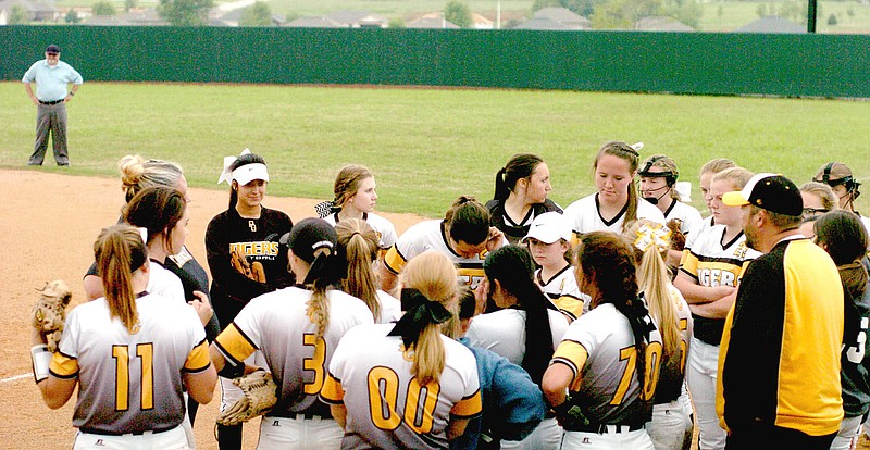 MARK HUMPHREY ENTERPRISE-LEADER/Prairie Grove coach Dustin Beck talks to the Lady Tigers softball team between innings. Prairie Grove defeated Berryville, 14-4, on Thursday to qualify for the 4A North Regional tournament this week at Dover.