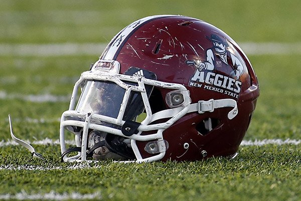 The helmet of a New Mexico State player lies on the field during an NCAA college football game against Louisiana-Monroe in Las Cruces, N.M., Saturday, Nov. 22, 2014. (AP Photo/Andres Leighton)
