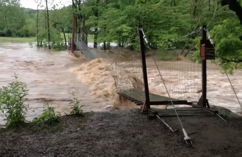 A 150-foot-long swinging bridge that spanned the Mulberry River between Oark and Catalpa was washed away by rising floodwaters Saturday.