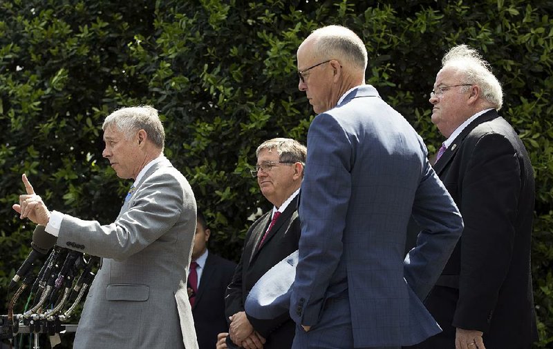 Rep. Fred Upton (left) of Michigan joins other Republican lawmakers at a news conference Wednesday outside the White House after they met with President Donald Trump on health care repeal legislation. Upton and Rep. Billy Long (right) of Missouri said they now support the bill.