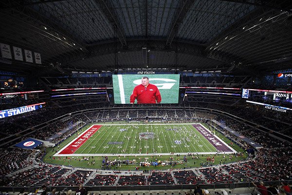 Arkansas head coach Bret Bielema is shown on the large video screen as teams warm up before an NCAA college football game against Texas A&M at AT&T Stadium on Saturday, Sept. 24, 2016, in Arlington, Texas. (AP Photo/Roger Steinman)

