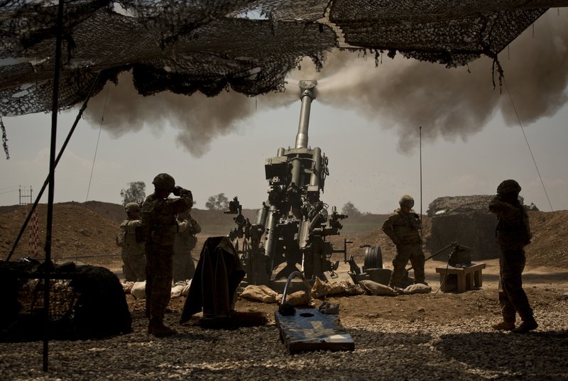 In this April 17, 2017 file photo, U.S. soldiers from the 82nd Airborne Division fire artillery in support of Iraqi forces fighting Islamic State militants from their base east of Mosul. 
