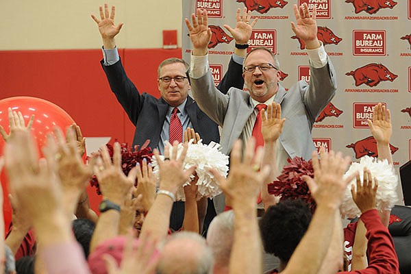 Arkansas women's basketball coach Mike Neighbors, right, and athletics director Jeff Long lead a Hog call during Neighbors' introductory press conference on Tuesday, April 4, 2017, in Fayetteville. 