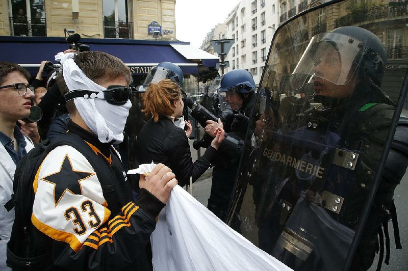 High school students face off with riot officers Friday during a demonstration in Paris on the last day of campaigning before France’s presidential runoff election Sunday.
