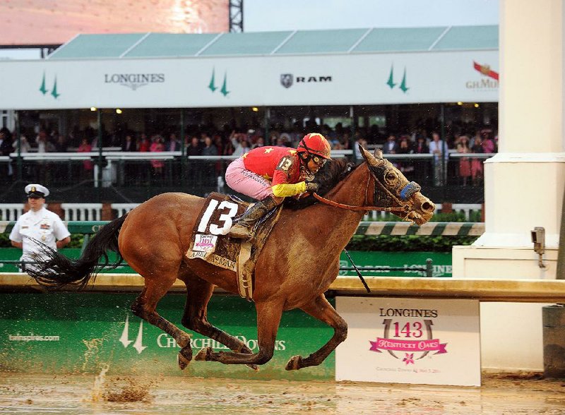 Mike Smith rides Abel Tasman to victory in the Kentucky Oaks. Abel Tasman won the 1 1/8-mile race by a 1¼ lengths over Daddys Lil Darling in 1:51.62. 
