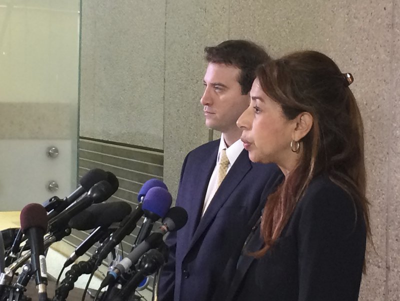 Defense attorneys David Wooten and Maria Mena speak in Rockville, Md., Friday, May 5, 2017, after charges were dropped against two Hispanic teens accused of raping a 14-year-old girl in a Maryland high school restroom. 