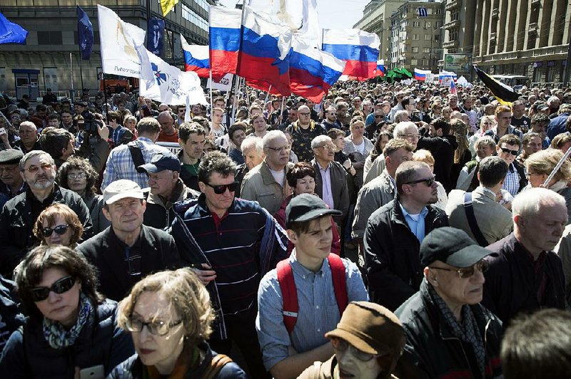 Demonstrators carry Russian flags Saturday during an opposition rally in Moscow. 