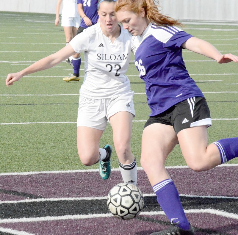 Graham Thomas/Siloam Sunday Siloam Springs junior Audrey Maxwell, left, battles with El Dorado defender Kendal Bonsall for the ball during the 6A-West Conference Tournament semifinals Thursday at Panther Stadium. Siloam Springs defeated El Dorado 7-1 and advanced to Saturday&#8217;s championship match against Russellville. Results were not available at presstime.