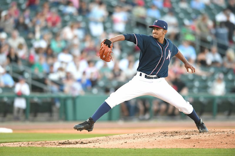 Northwest Arkansas Naturals pitcher Emilio Ogando delivers a pitch Saturday during his double-A debut against the Arkansas Travelers at Arvest Park in Springdale.