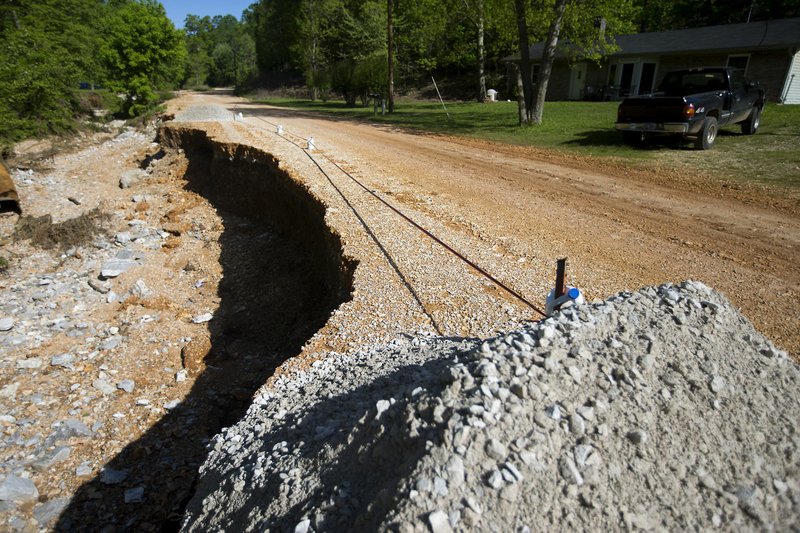 NWA Democrat-Gazette/JASON IVESTER A washed out portion of Esculapia Hollow Road is seen Friday in Rogers.