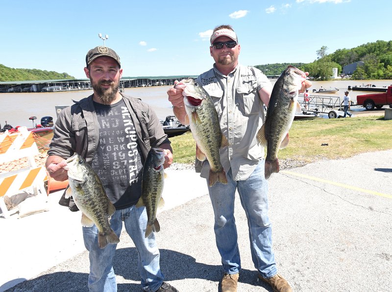 Dustin Simon (left) and Rance Carter show largemouth bass from their winning catch Saturday May 7 2017 at Beaver Lake. They had five bass at 17.03 pounds and won a bass boat, motor and trailer. 