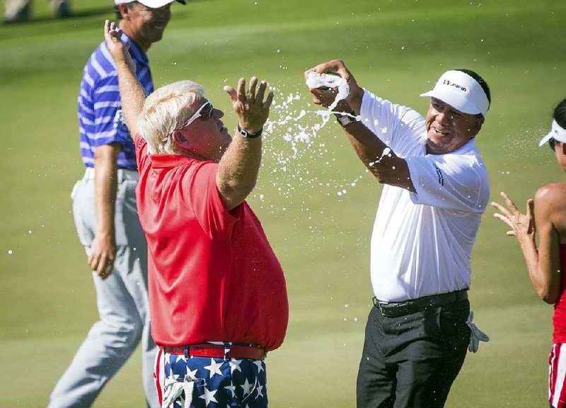 Dardanelle’s John Daly (left) is doused with champagne by Estebon Toledo on Sunday after winning the Insperity Invitational PGA Tour Champions event. It was Daly’s fi rst victory since 2004.