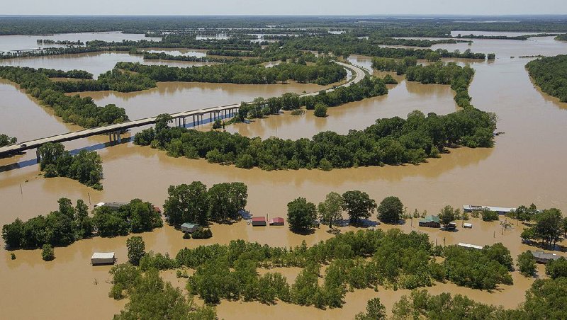 Houses along Taylor Bay Road in Augusta are flooded by the swollen White River on Sunday. At center left is an elevated section of U.S. 64.