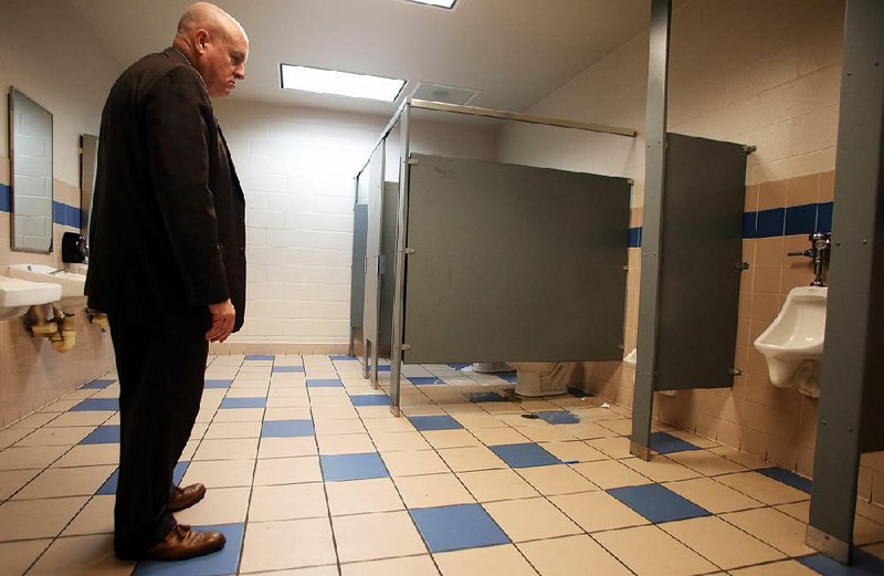 Little Rock School District Superintendent Mike Poore views an unusable restroom at McClellan High School during a recent tour. The district’s millage proposal would include a $90 million high school in southwest Little Rock to replace McClellan and J.A. Fair. 