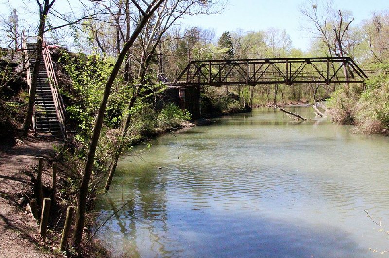 The southern trailhead for Clarksville’s Scout Trail features an old iron bridge and stairs to get down to the path.