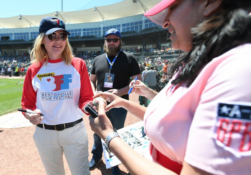 NWA Democrat-Gazette/J.T. WAMPLER Geena Davis signs autographs Sunday during the A League of Their Own reunion softball game at Arvest Ballpark in Springdale. The event concluded the Bentonville Film Festival.